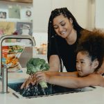 mom-teaching-daughter-to-wash-vegetables-by-tyson-at-unsplash