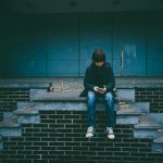 boy-with-smartphone-on-empty-old-dark-stage-gaelle-marcel-unsplash