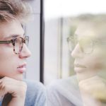 man-wearing-glasses-looking-out-the-window-bylaurenz-kleinheider-at-unsplash