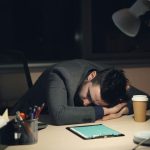 man-sleeping-at-desk-with-coffee-and-tablet-vitaly-gariev-unsplash