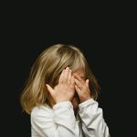 anxious-kids-covering-face-with-both-hands-by-caleb-woods-at-unplash