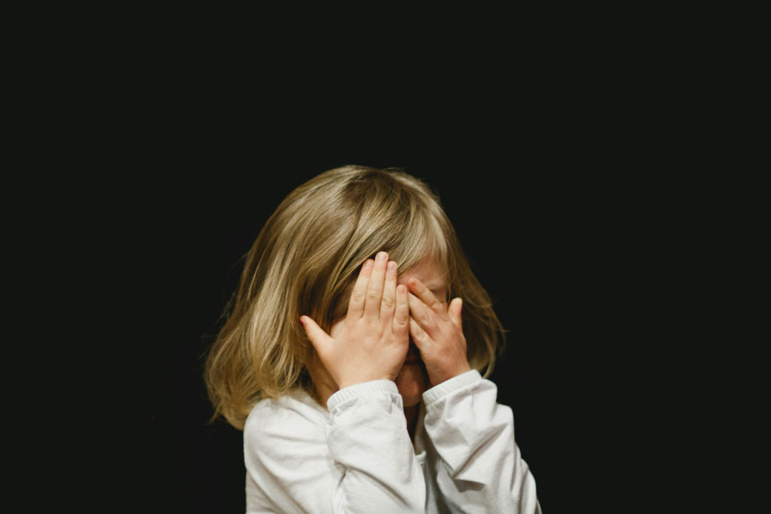 anxious-kids-covering-face-with-both-hands-by-caleb-woods-at-unplash