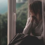 woman-sits-by-the-window-gazing-out-by-ruslan-sikunov-at-unsplash