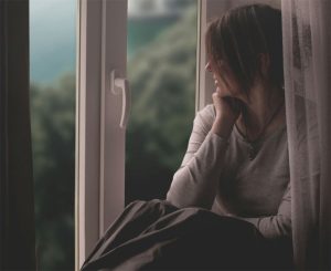woman-sits-by-the-window-gazing-out-by-ruslan-sikunov-at-unsplash