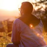 man-sitting-watching-sunset-mitchell-hartley-unsplash
