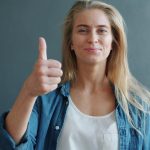 fulfilled-woman-thumbs-up-vitaly-gariev-unsplash