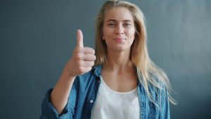 fulfilled-woman-thumbs-up-vitaly-gariev-unsplash