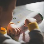 kid-answering-book-after-school-stephen-andrews-unsplash